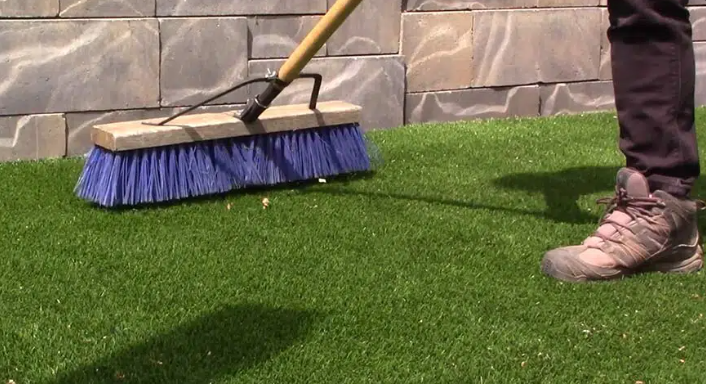 brushing synthetic grass