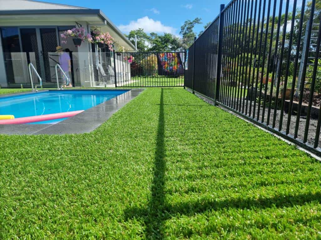 Swimming pool with synthetic grass surrounds